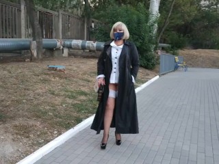 Slut walking in the park in a raincoat and black fishnet stockings with a white elastic band