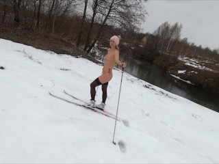 Naked girl skiing in the countryside