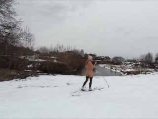 Naked girl skiing in the countryside