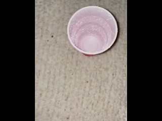 Piss spray into solo cup 