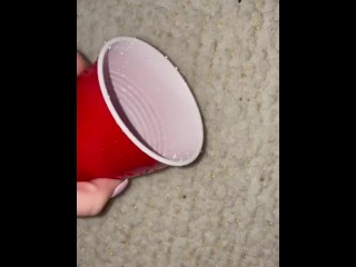 Piss spray into solo cup 