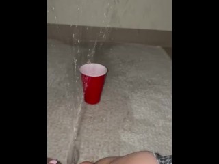 Piss spray into solo cup 