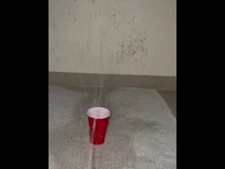 Piss spray into solo cup 