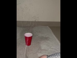 Piss spray into solo cup 