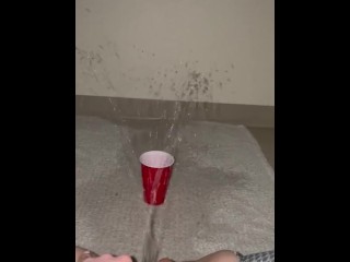 Piss spray into solo cup 