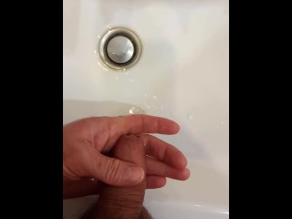 I pee in the bathroom on my palm. I jerk off and wash my dick.