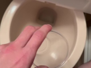 Pissing in a plastic cup.