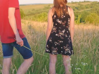 Spanking by cane of a girl in the field outdoor