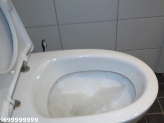 Sexy girl standing peeing in the toilet