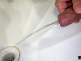 Guy solo pissing in the sink.