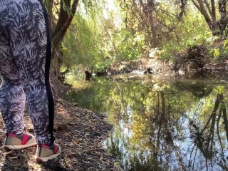 MILF dressed in leggings pissing in the river