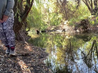 MILF dressed in leggings pissing in the river