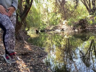 MILF dressed in leggings pissing in the river