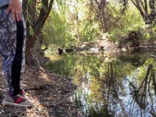 MILF dressed in leggings pissing in the river