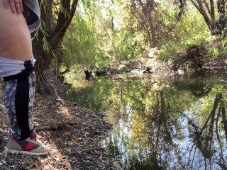 MILF dressed in leggings pissing in the river