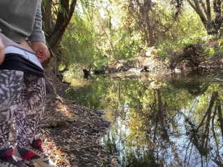 MILF dressed in leggings pissing in the river