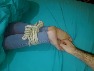 Tickling wife's tied feet in the bed