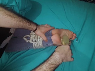 Tickling wife's tied feet in the bed