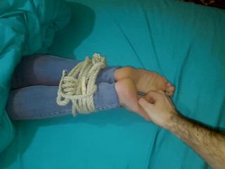 Tickling wife's tied feet in the bed