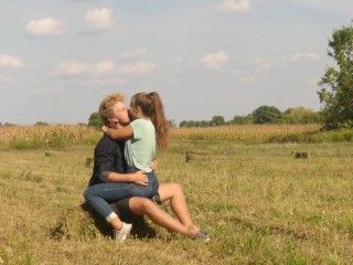 Beautiful Teen Couple in Love Passionately Kissing on the field