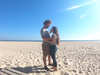 Hot teen couple in love kissing on a sandy beach