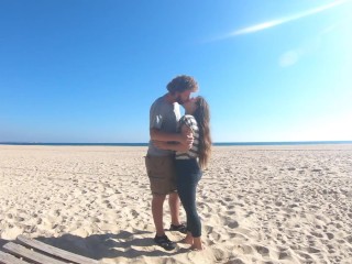 Hot teen couple in love kissing on a sandy beach