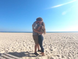 Hot teen couple in love kissing on a sandy beach