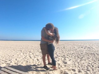 Hot teen couple in love kissing on a sandy beach