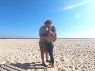 Hot teen couple in love kissing on a sandy beach