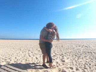 Hot teen couple in love kissing on a sandy beach