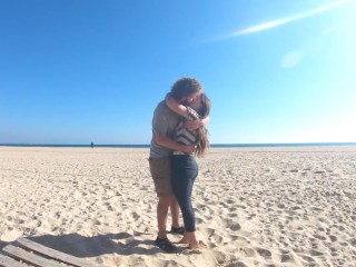 Hot teen couple in love kissing on a sandy beach