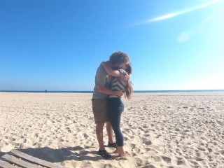 Hot teen couple in love kissing on a sandy beach