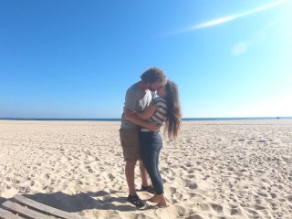 Hot teen couple in love kissing on a sandy beach