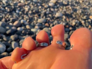 Hot and sexy feet of Mistress Lara in the sunset on public beach