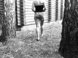 Slim big booty MILF peeing in a secluded outdoor spot.