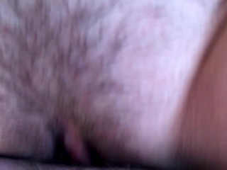 Cum flows from a meaty, swollen and fucked up pussy. Close-up.