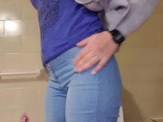 Girl with great ass peeing in her jean pants and playing with her pussy