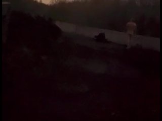 Standing naked at side of road trying to hide from cars