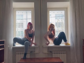 Two girls are smoking on the window