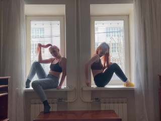 Two girls are smoking on the window
