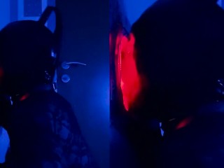 sissy with latex mask sucking cock at gloryhole