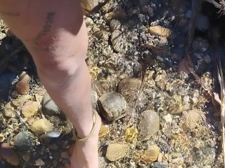 Walking barefoot in the river. Hairy legs. Ankles jewelery.
