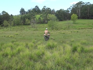 Naked man riding a Dirt bike