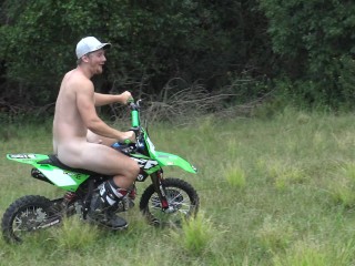 Naked man riding a Dirt bike