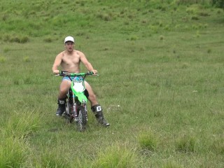 Naked man riding a Dirt bike