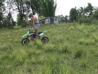 Naked man riding a Dirt bike