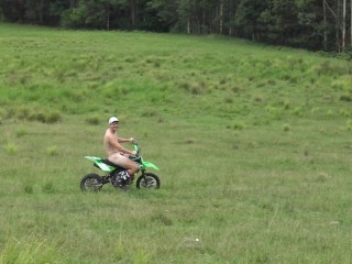 Naked man riding a Dirt bike