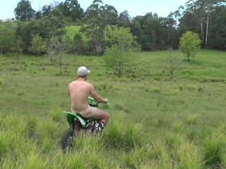 Naked man riding a Dirt bike