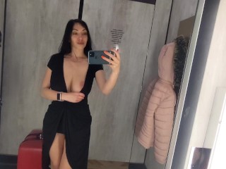 Busty  hot brunette is trying dresses in the store