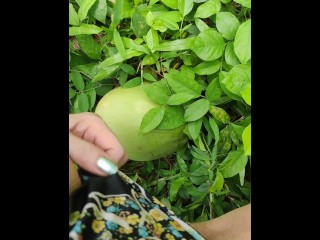 Girl pissing on the coconut in the jungle grass